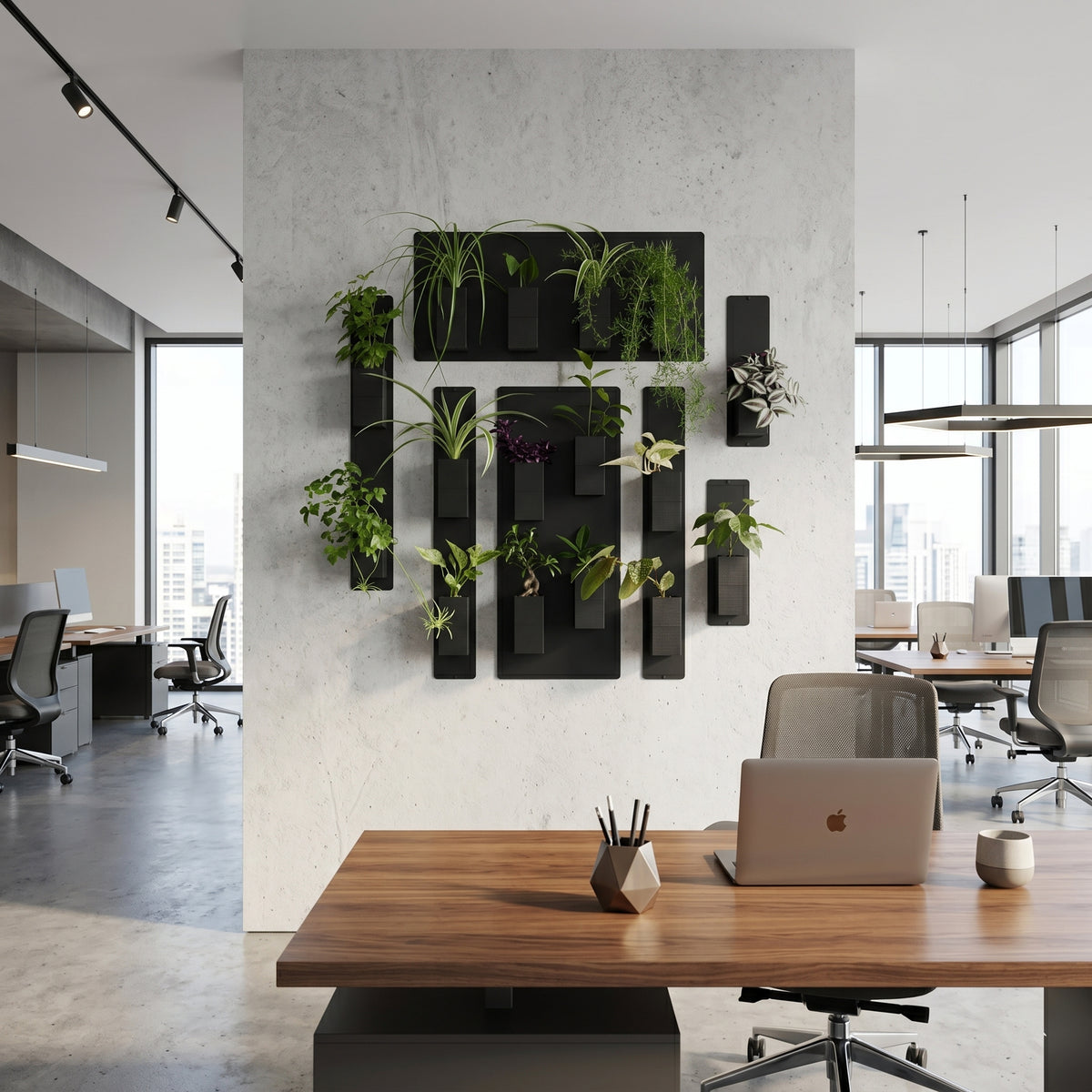 Aménagement végétal de bureau par Éclance décoration intérieur végétal : grand mur végétal modulaire installé sur un pilier en béton brut au centre d'un open space moderne et lumineux. La composition est formée de plusieurs panneaux magnétiques noirs habillés de cache-pots Le cube tout noir, adaptés pour des pots de 6cm, contenant des plantes vertes d'intérieur. Au premier plan, un poste de travail design avec un bureau en bois et un ordinateur portable.